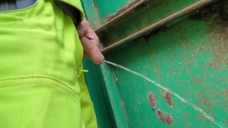 construction worker takes a risky piss at work