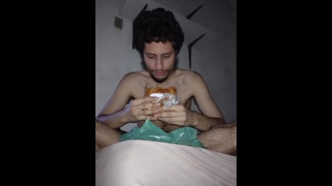 Man with fat fetish eating hot dog in his room