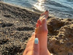 Mistress Lara plays with her feet and toes on the beach