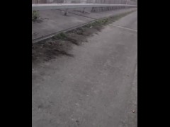 Naked barefoot walk over road bridge 
