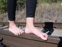 Barefoot walking and dirty feet on rails (long toes