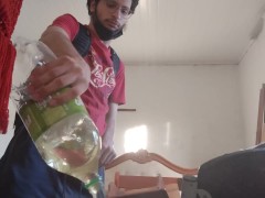 Backpack man Pissing in a bottle before leaving home and pluging