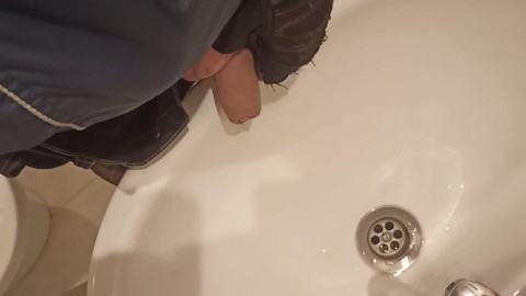 Guy pisses in the sink