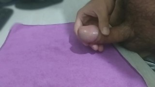 Cumming on top of a purple fabric