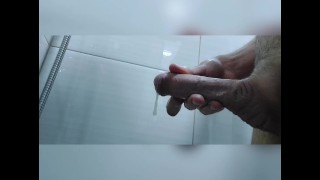 Young horny twink stroking his dick in the shower with a good load in the end
