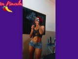 Senhora Pimenta does a Striptease while sensually smoking a cigar.