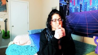 Smoking goth girl makes herself squirt