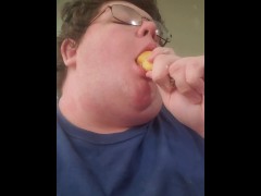 Fat male testing throat with banana