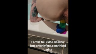 Slut fucks rainbow dildo in bath