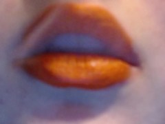 Smoking With Orange Lips and a wicked smirk