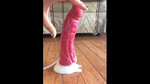 Giving a handjob to a cumming dragon dildo