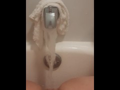Chubby blonde cums using bathtub faucet