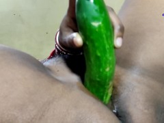 Desi indian teen girl using cocumber on camera