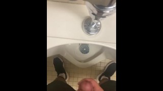 Jerking off in a public urinal 