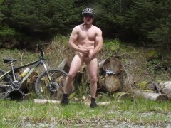 Muscle stud gets naked on a bike ride in the woods