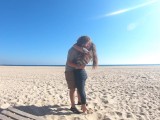 Hot teen couple in love kissing on a sandy beach