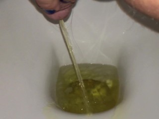 Urination into the Toilet with Yellow Urine