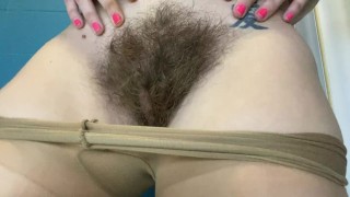 Close-Up Of A Highly Hairy Pussy In Pantyhose