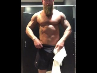 Fit Tattooed Man Strips in Gym Locker Room