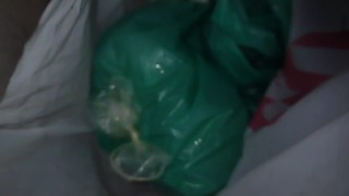 White bag with condom on it filled up with CUM