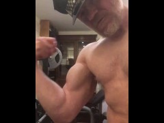 Naked horny muscular cop wearing his police hat turns himself on flexing his big bicep and cums