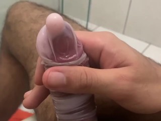 Jerking off Playing inside the Condom Full of Cream Conditioner .