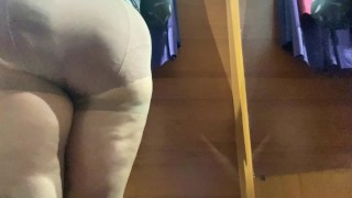 Curvy MILF in the mall fitting room trying on skirts