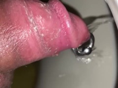Nasty pierced cock pissing