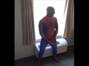 Preview 2 of spiderman in black silicone mask jerking off at hotel window
