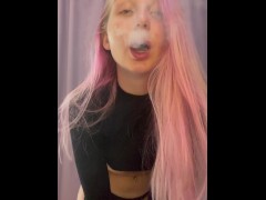 Girl with pink hair smokes at home