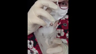 Girl plays with cum in medical gear