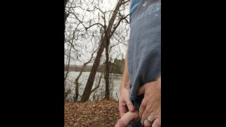 Ginger pissing outdoors at the river