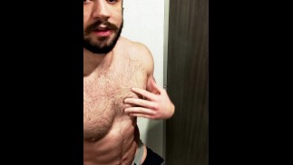 Horny jock plays with his thick cut cock in the gym showers