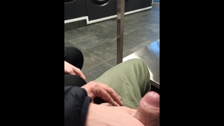 At the laundromat, a Guy offers to give a handjob to a Guy who accepts