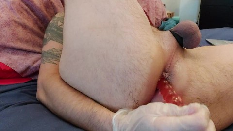 straight man inserting a pink toy in his ass