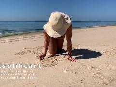Nude public beach sunbathing with people passing by