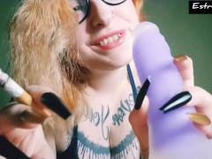 Red-haired girl with long nails smokes a cigar and is full of smoke