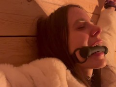 Girl in fur coat chained to wall and toyed to orgasm by magic wand