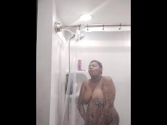 Using the showerhead to cum trying not to scream