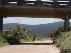 Walking Naked on open road under a bridge
