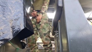 Horny Colombian soldier jerks off on a military boat in public