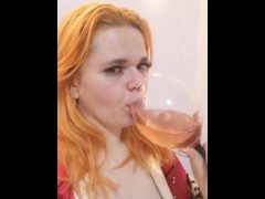 red-haired sexy girl drink vine and dream aboyte you