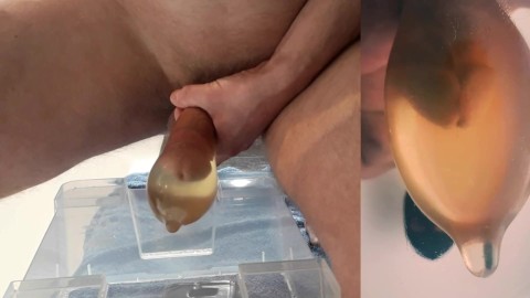 beautiful hard cock pisses in condom and fucks his pee into big cumshot with floating sperm