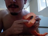 Handsome guy fucks a papaya, cums inside and eats it