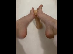 Sexy girl in the bathroom masturbating with her feet and herself
