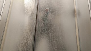 hot guy rubs his hard cock on the glass in the shower