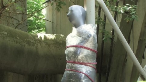 Bondaged and cocooned slave girl in the mystery garden - Full encasement fetish in zentai body bag