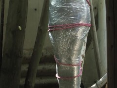 Bondaged and cocooned slave girl in the mystery garden - Full encasement fetish in zentai body bag