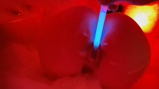 Blue neon enters her pussy, engulfing her in red flames.