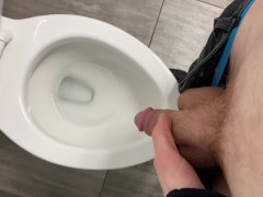 Pissing in a public toilet.